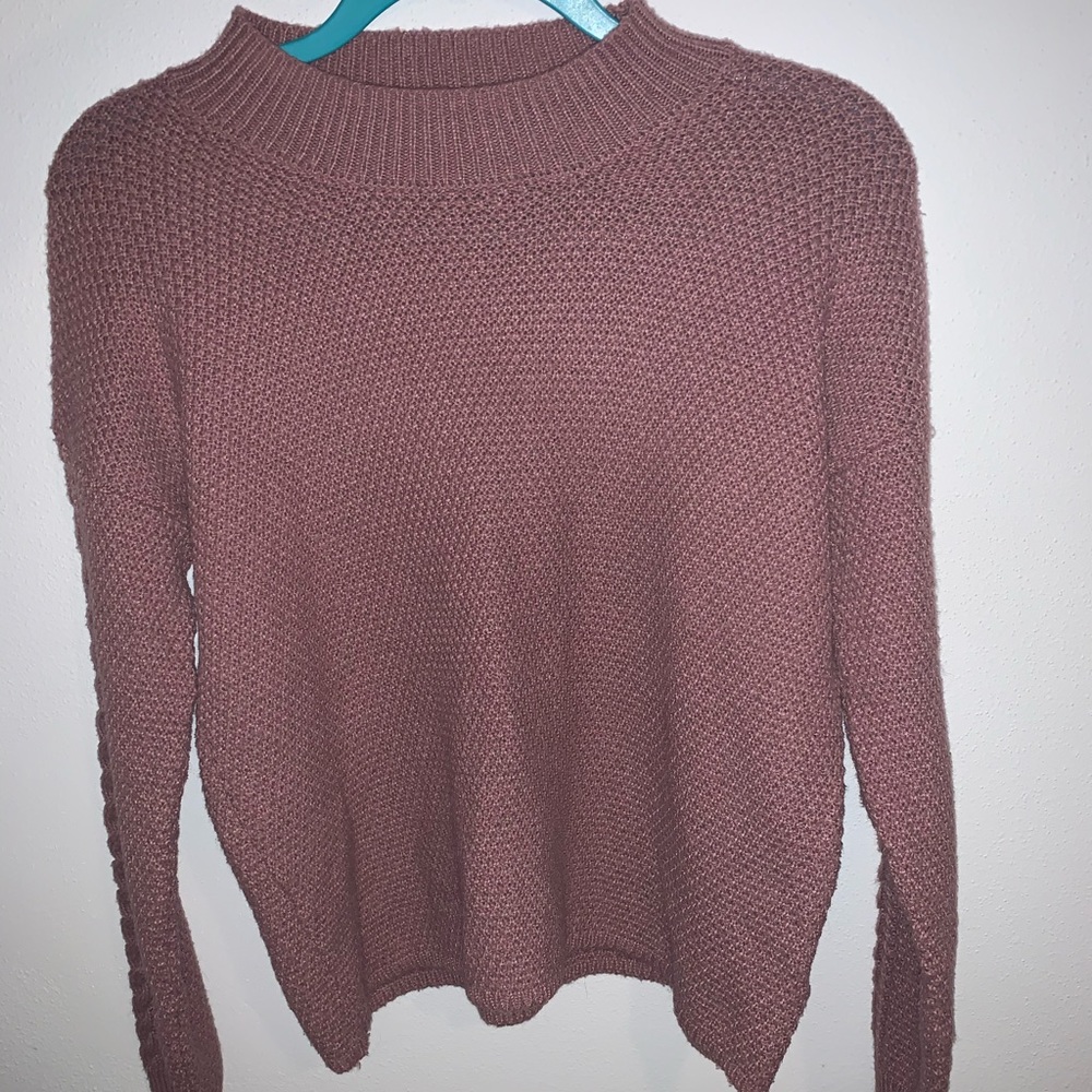 A pink sweater.